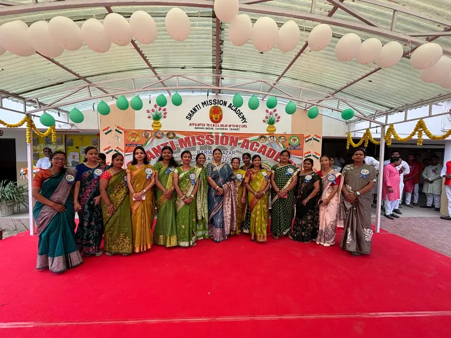 The women teachers before the school banner
