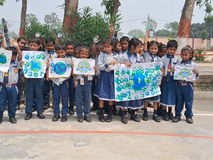 Students with earth-day posters on the ground